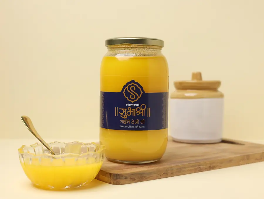A 1 kg jar of cow ghee on a wooden board